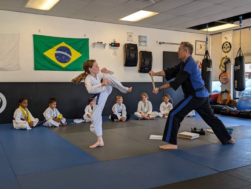 Martial arts instructor teaches a youth class at On Track Wellness